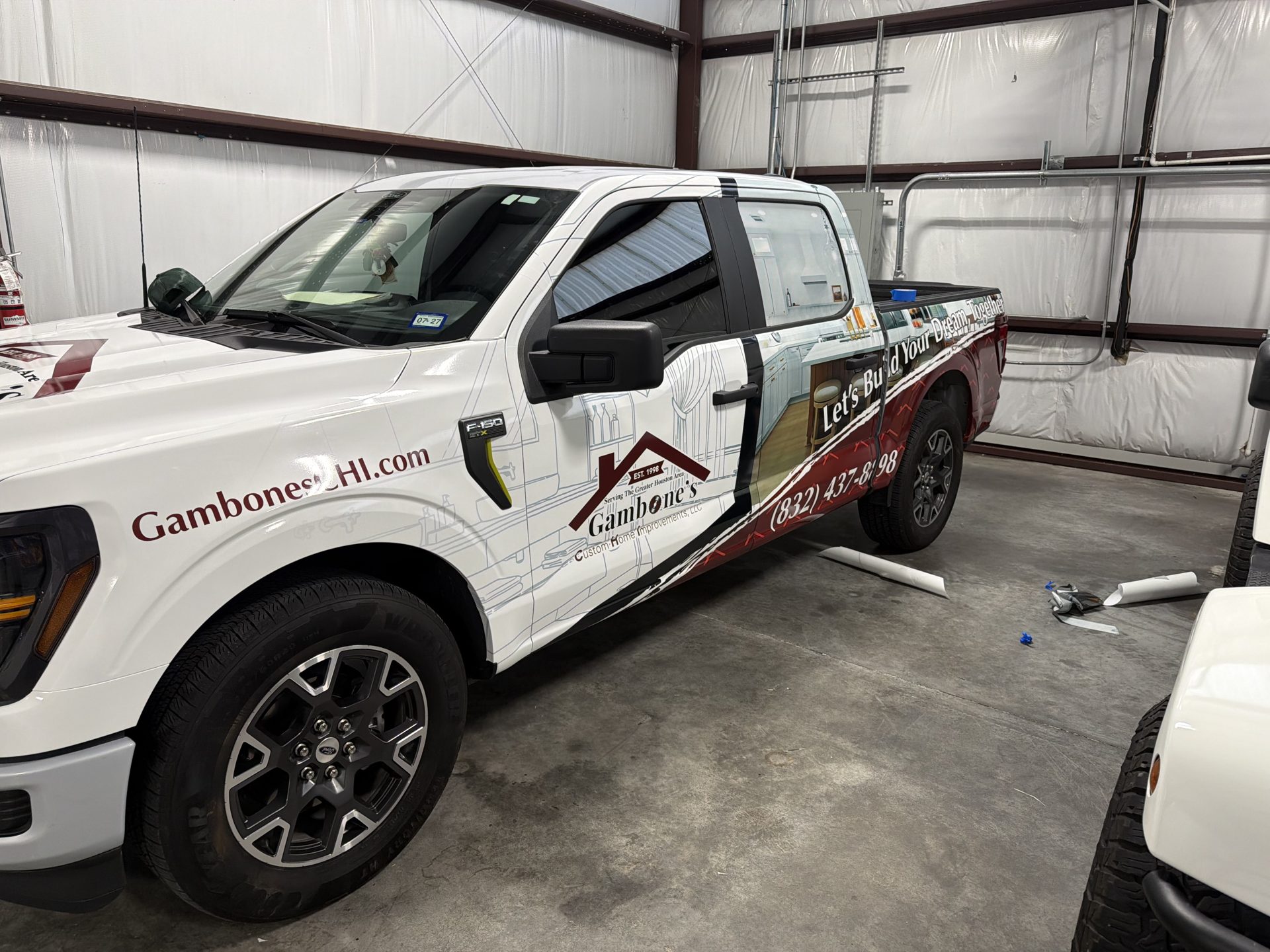 Recently completed pickup truck wrap with maroon graphics